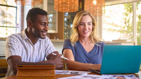 Couple Working From Home In Design Publishing Or Creative Industry With Digital Tablet With Stylus