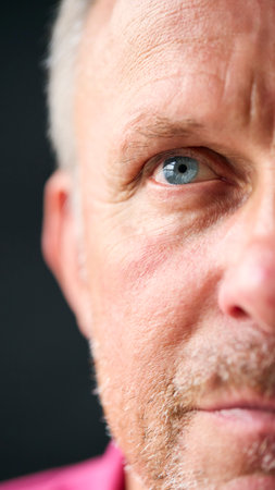 Macro Studio Expression Shot Of Senior Man's Eyes With Close Up On Eyelashes And Pupilの写真素材