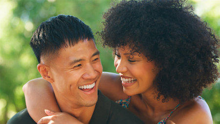 A joyful couple enjoys a lighthearted moment in nature.
