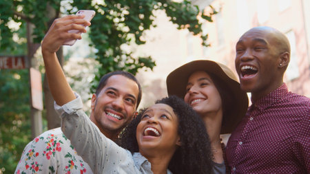 Multi-Cultural Group Of Friends With Mobile Phone Posing For Selfie On Street In New York Cityの写真素材