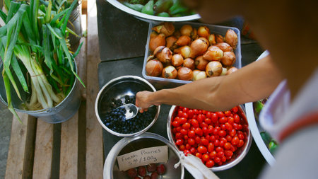 Close Up Of Woman Putting Blueberries Into Reusable Cotton Bag In Plastic Free Grocery Store