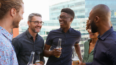 Multi-Cultural Business Team Meeting Outdoors For After Work Drinks On Office Rooftop Or Bar
