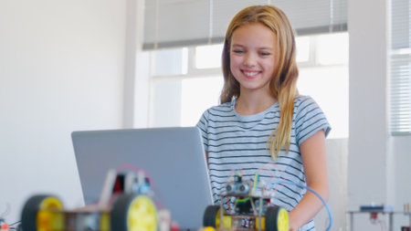 Female Student Building And Programming Robot Vehicle In After School Computer Coding Classの写真素材