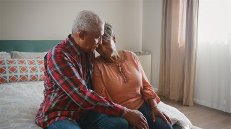 Senior Man Comforting Unhappy Woman With Depression In Bedroom At Homeの写真素材
