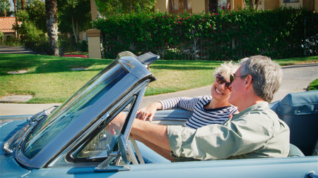 Side View Of Senior Couple On Road Trip Driving In Classic Convertible Carの写真素材