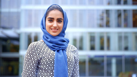 Portrait Of Smiling Young British Muslim Businesswoman Wearing Hijab Outside Officeの写真素材