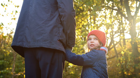 Close Up Of Loving Grandfather Holding Hands With Granddaughter On Autumn Walk Through Countrysideの写真素材