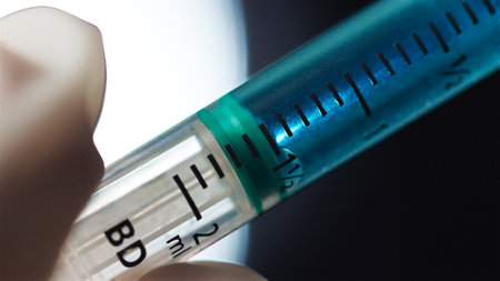 Close Up Of Syringe Being Prepared For Injection Or Vaccination