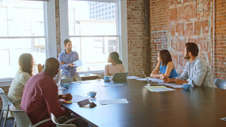 Businessman Leading Meeting With Colleagues In Boardroomの写真素材