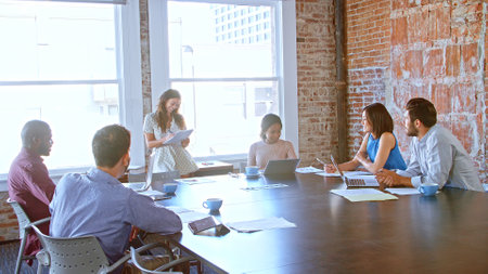 Businesswoman Leading Meeting With Colleagues In Boardroomの写真素材