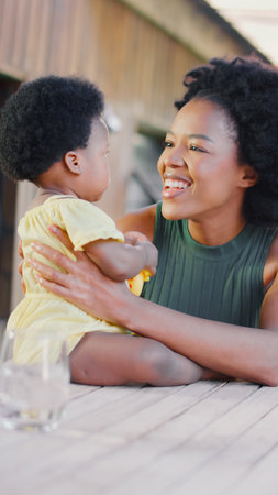 Mother Playing With Young Daughter And Her Toys Outdoors At Homeの写真素材