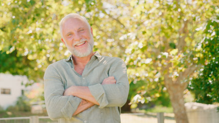 Portrait Of Smiling Senior Man Standing Outdoors In Garden Park Or Countryside