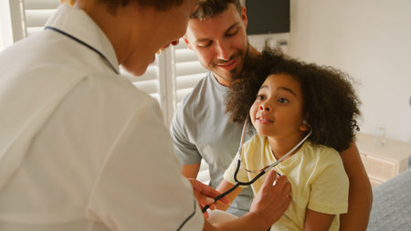 Nurse Wearing Uniform Gives Girl Stethoscope To Listen To Her Own Chest In Private Hospital Roomの写真素材