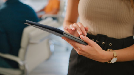 Close Up Of Businesswoman With Digital Tablet Standing And Working In Modern Officeの写真素材