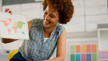Female Elementary School Teacher In Geography Class At School