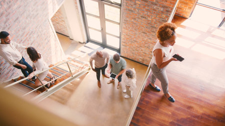 Stairwell Of Busy Modern Office With Business Colleagues Meeting And Using Digital Tech