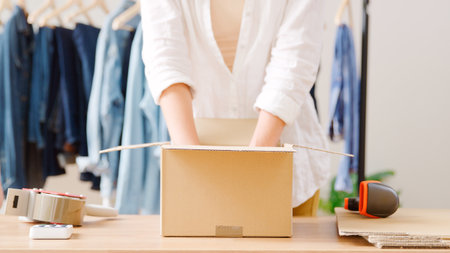 Close Up Of Woman Running Online Fashion Business Packing Order For Shipping