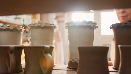 Group Of Glazed And Vases On Shelves Of Ceramics Studioの写真素材