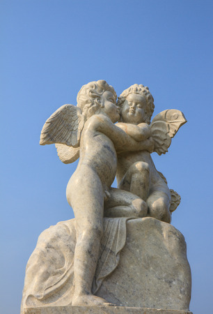 A little miniature statue of a white angel with wingsの写真素材