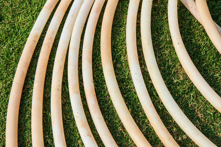 Rubber tube on green grass field