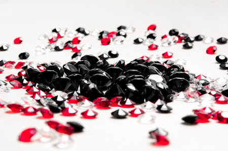 Black, red and white diamonds on white background.の写真素材
