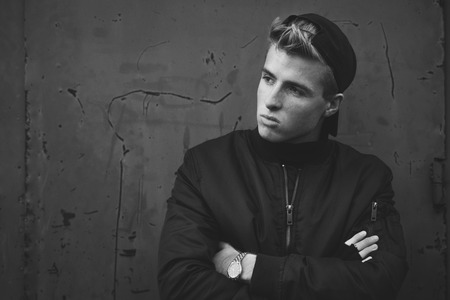 Young handsome blond haired hooligan portrait with hatの写真素材