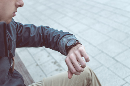 Handsome stylish man checking the timeの写真素材