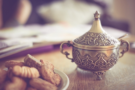 Sugar bowl and cookies on the table, faded filter authenticの写真素材