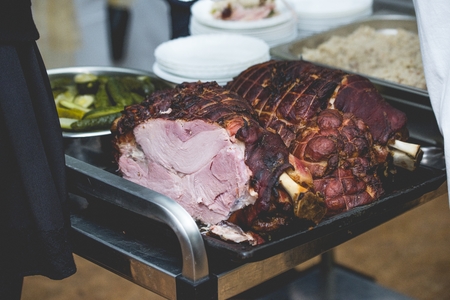 roasted meat of wild boar at white plate with cucumber and barleyの写真素材