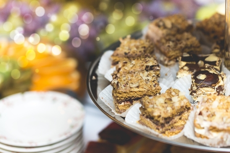 Piece of cakes lying on the metal plate at the buffet tableの写真素材