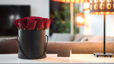Roses in black box standing on the white table