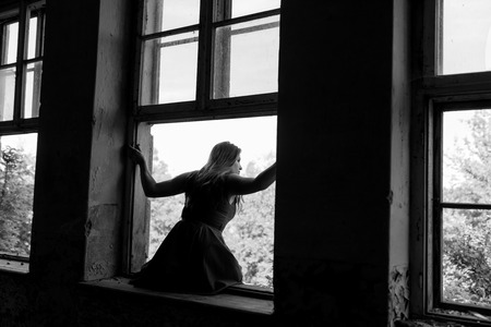 The suicide girl wants to jump out of the windowの写真素材