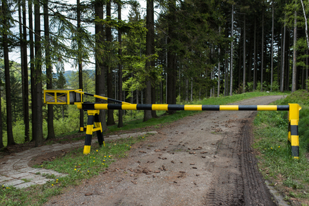 Iron barrier on the border of the state in the forest.