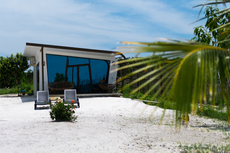 Beautiful white modern concrete bungalow with blue mirrored windows on the tropical island beach have been handed for use in september 2017. Koh Rong Island, Cambodia Asia.のeditorial素材