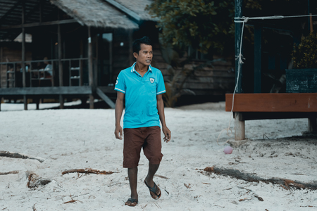 Happy cambodian man walking at the beach. 13 September 2017. Saracen Bay beach, Koh Rong Sanloem....