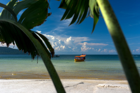 Yellow longtail boat moored at the beach in Koh Rong Samloem island, Cambodiaの写真素材