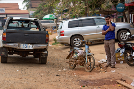 Cambodian man talking by cellular phone at the street of Banlung city. Cambodia 02 march 2018.のeditorial素材