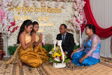 Family members thanks to their parents kneeling in front of them. Kampot 07 july 2018, Cambodia.のeditorial素材