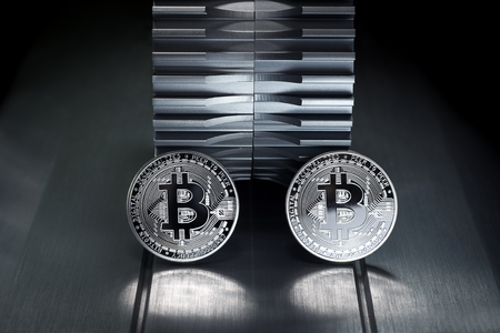 Silver bitcoin stand on metal with gearwheel in the background. Digital Crypto currency revolution.の写真素材