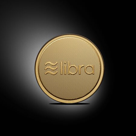 Concept of golden Libra coin with logo on front. New project of digital crypto currency payment. 3D render Coin placed on a black background.の写真素材