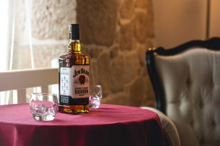 Jim Beam standing on a table with whiskey glass. Produced by Beam Inc. in Clermont, Kentucky. 17 June 2017 Wroclaw, Poland.のeditorial素材