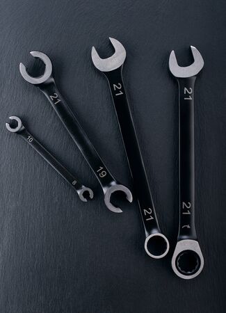 Professional reinforced Open end and Spanner Wrench tools placed on a dark background. View from the top.の写真素材