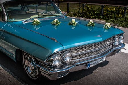 Front mask of 1962 CADILLAC DEVILLE sedan as a wedding car, standing on the street. Beautiful blue sky color. 02 august 2014 Wroc?aw, Poland.のeditorial素材