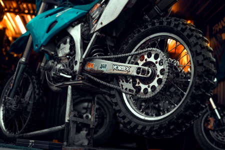 27 March 2020 Wroclaw - Back wheel of motocross Yamaha WR 250r. Motorcycle stands in front of a workshop on motorbike stand, waiting for components inspection before moto season.のeditorial素材