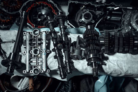 Disassembled fast motorcycle engine with visible transmission, locking valve, gear and piston parts. Sixteen valves and four cylinder motor.の写真素材