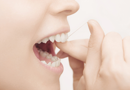 Dental floss in mouth, dental care