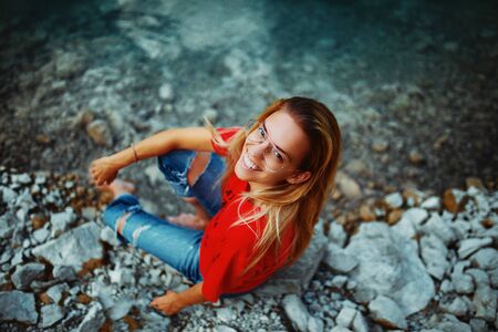 Outdoors portrait of beautiful young girl laughingの写真素材