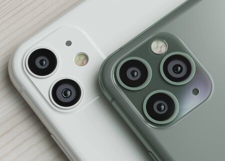 ITALY -22 SEPTEMBER, 2019: Iphone 11 smartphones on table. Iphone 11 in close up. Latest Apple Mobile iphones model. Illustrative editorial.のeditorial素材