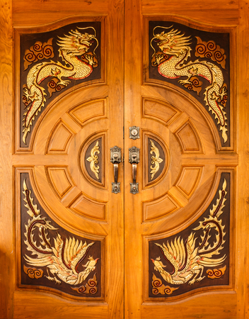 Wood door with dragons and swans designの写真素材