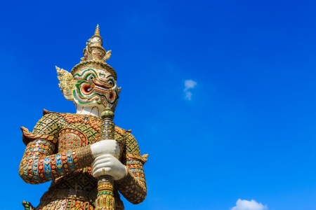 The statue of giant hold club and blue sky in Wat Phra Kaew ,Thailandの写真素材